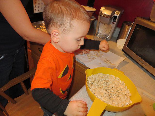 Helping Mommy prepare seeds for baking