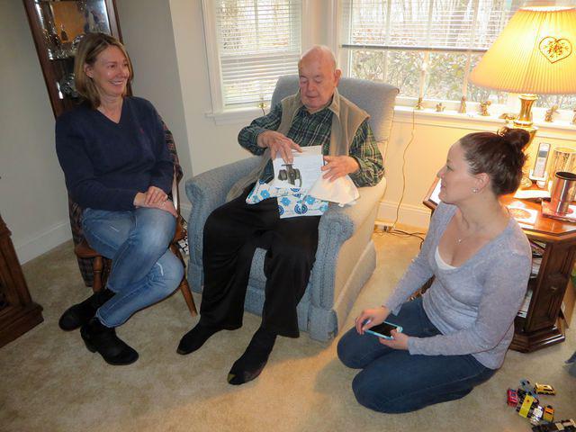 Laurie and Meg watching Dad open his TV headset