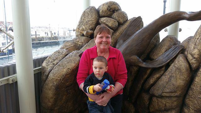 Wanting to play with his new truck, not pose