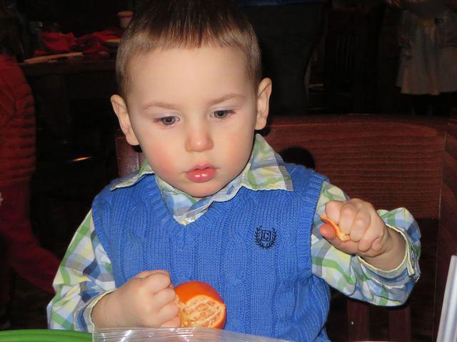 Peeling his own clementine