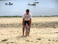 Grandpa and Thomas walking along the beach