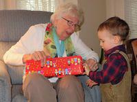 Thomas opening his gift from Grandparents-the-Great