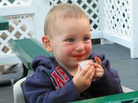 So hungry, he is eating catsup