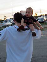 Tired boy getting a shoulder ride to the car