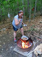 Breanna demonstrating campfire baking
